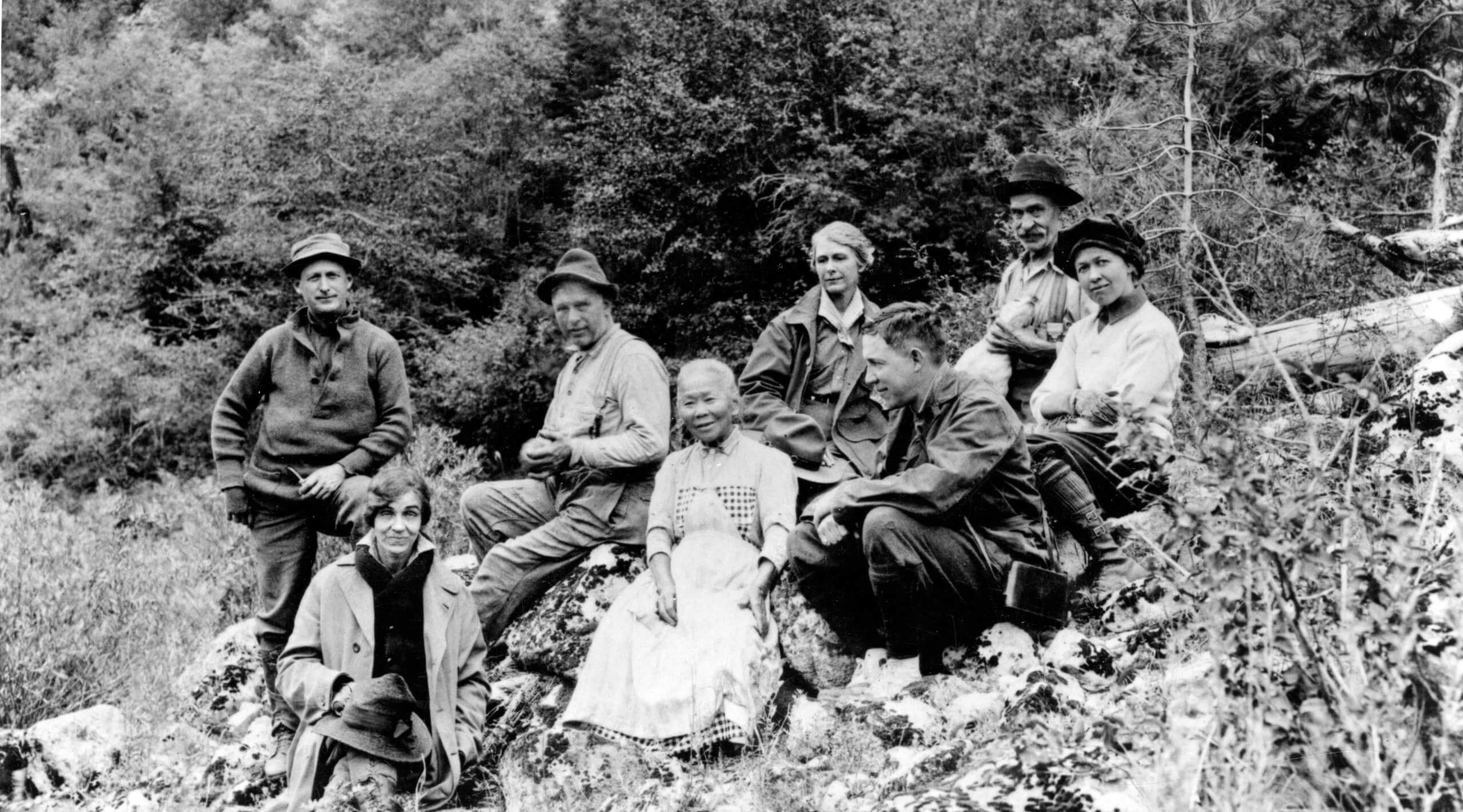 A black-and-white photo of Polly Bemis sitting with a group of seven people on an outing with Captain Guleke.